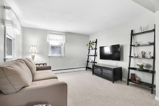 carpeted living area with a baseboard heating unit, a textured ceiling, and baseboards