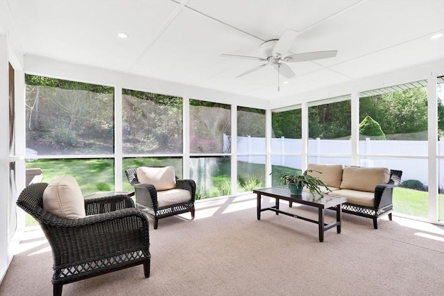 sunroom with ceiling fan and an outdoor living space