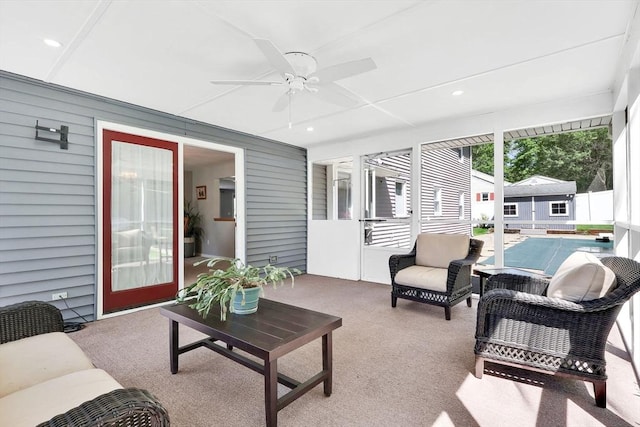 sunroom / solarium with ceiling fan and an outdoor hangout area