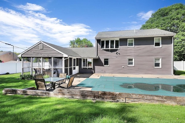 back of house with a patio, a sunroom, and roof with shingles