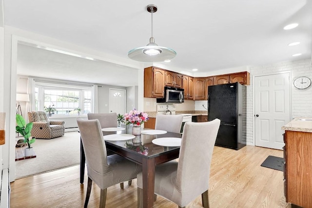 dining room featuring light wood-style floors, recessed lighting, and baseboard heating