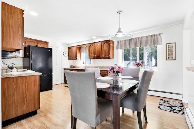 dining room featuring a baseboard heating unit, recessed lighting, light wood-type flooring, and a ceiling fan