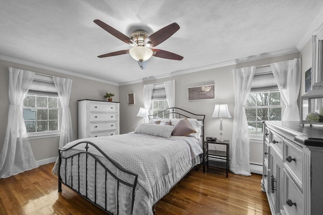 bedroom with ornamental molding, dark hardwood / wood-style floors, and multiple windows