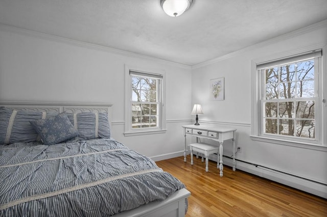 bedroom featuring ornamental molding and hardwood / wood-style floors