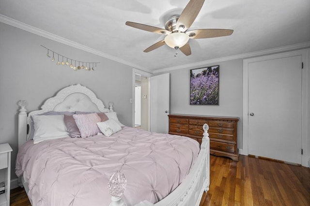 bedroom featuring dark wood-type flooring, ornamental molding, and ceiling fan