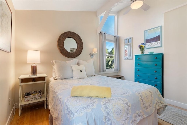 bedroom with baseboards and wood finished floors