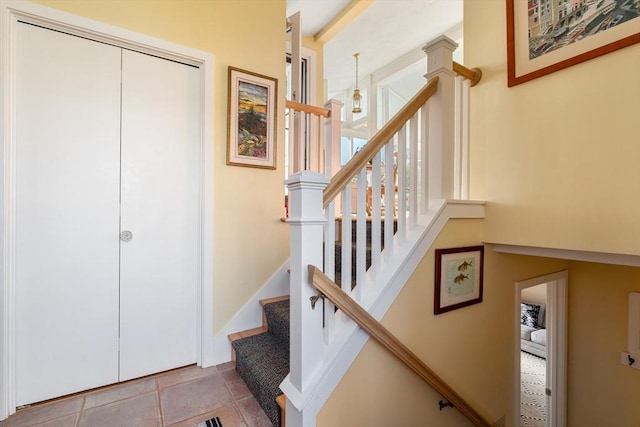 stairway featuring tile patterned flooring