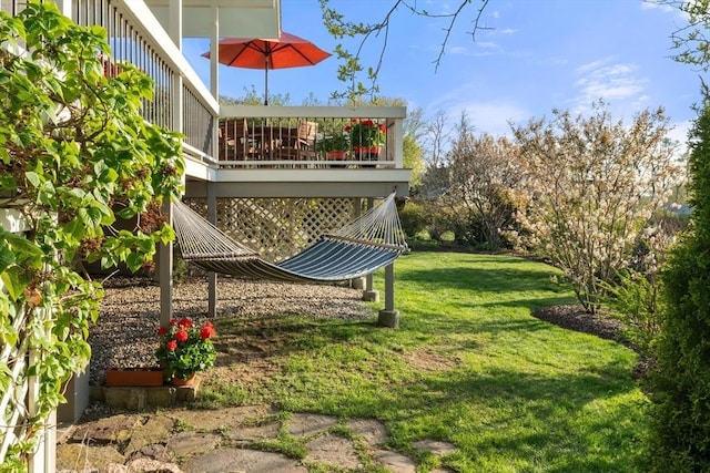 view of green lawn featuring a wooden deck