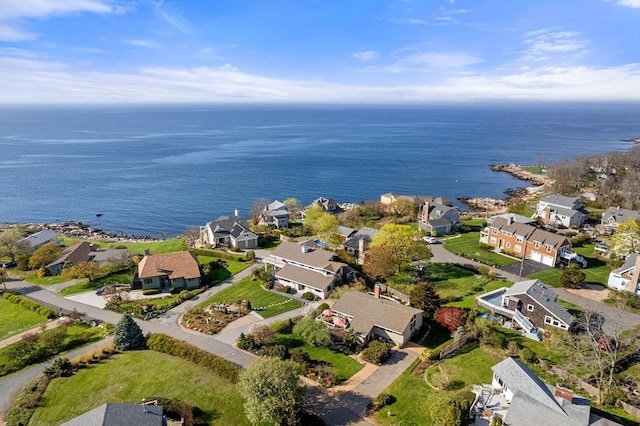 aerial view of property's location with nearby suburban area and a nearby body of water