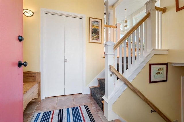 staircase featuring tile patterned floors