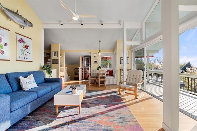 living room with wood finished floors and a ceiling fan