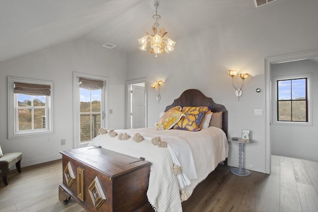 13 Parson Ln, Nantucket, MA 02554 - bedroom with visible vents, vaulted ceiling, wood finished floors, and a notable chandelier