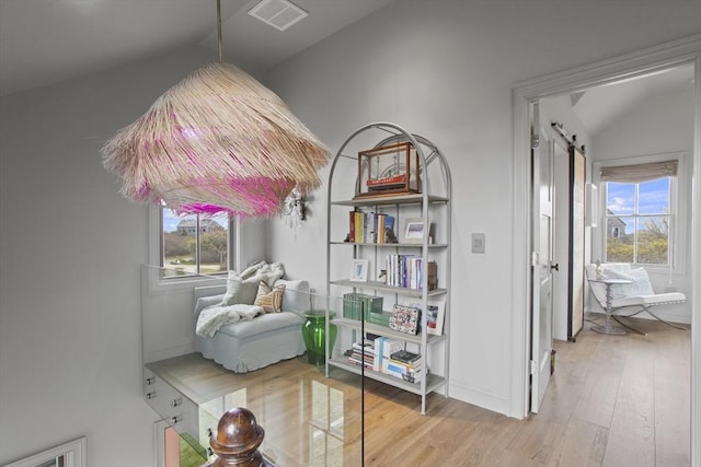 13 Parson Ln, Nantucket, MA 02554 - sitting room featuring visible vents, a barn door, wood finished floors, and lofted ceiling