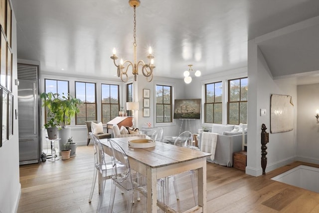 13 Parson Ln, Nantucket, MA 02554 - dining area with baseboards, a notable chandelier, and wood finished floors