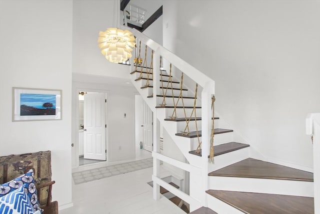 13 Parson Ln, Nantucket, MA 02554 - stairway featuring an inviting chandelier and a towering ceiling