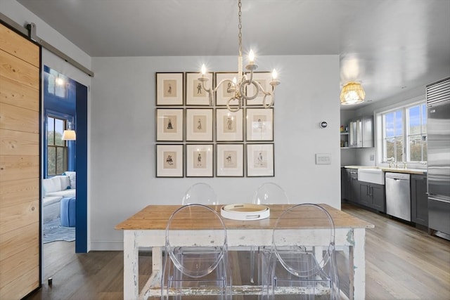 13 Parson Ln, Nantucket, MA 02554 - dining room with a notable chandelier, a barn door, and wood finished floors