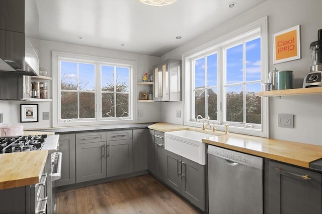 13 Parson Ln, Nantucket, MA 02554 - kitchen featuring wall chimney range hood, gray cabinets, open shelves, butcher block counters, and stainless steel appliances