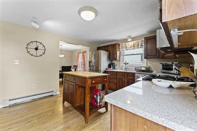 31 Wight St, Waltham, MA 02452 - kitchen with baseboard heating, stainless steel refrigerator with ice dispenser, a sink, light wood finished floors, and wood counters