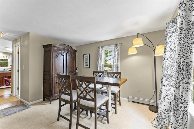 31 Wight St, Waltham, MA 02452 - dining room with baseboards, a baseboard heating unit, and light carpet
