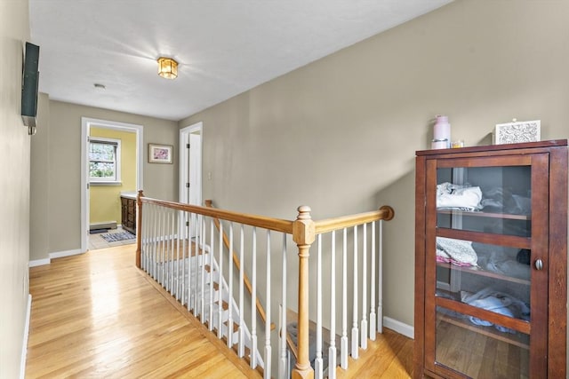 31 Wight St, Waltham, MA 02452 - hallway featuring baseboards, an upstairs landing, and wood finished floors