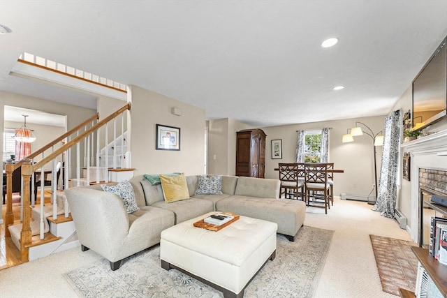 31 Wight St, Waltham, MA 02452 - living room with stairs, a fireplace, light carpet, recessed lighting, and a baseboard radiator