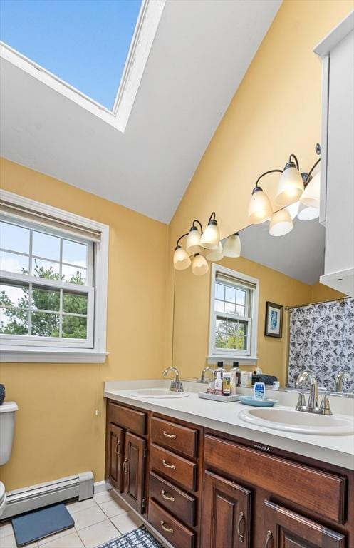31 Wight St, Waltham, MA 02452 - full bath featuring a sink, tile patterned flooring, baseboard heating, and lofted ceiling with skylight