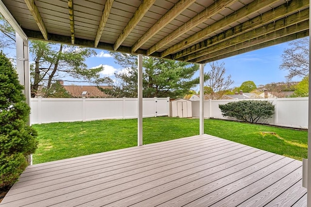 31 Wight St, Waltham, MA 02452 - wooden deck featuring a fenced backyard, an outdoor structure, a lawn, and a shed
