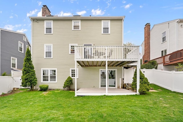 31 Wight St, Waltham, MA 02452 - rear view of house with a lawn, a fenced backyard, a patio area, and a chimney