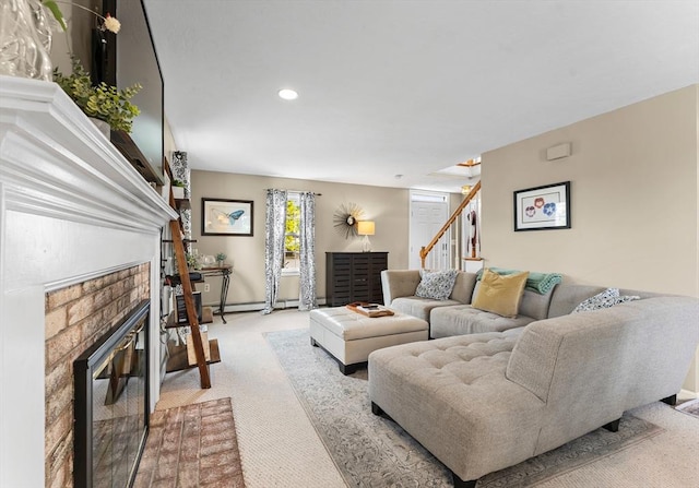 31 Wight St, Waltham, MA 02452 - living area featuring a brick fireplace, stairway, a baseboard heating unit, carpet, and recessed lighting