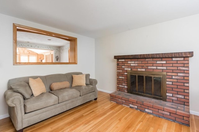221 Andrew Ln, Hanson, MA 02341 - living area featuring wood finished floors and a brick fireplace