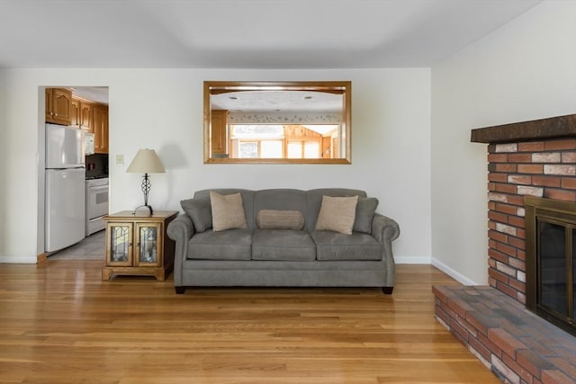 221 Andrew Ln, Hanson, MA 02341 - living area featuring light wood-type flooring and a fireplace