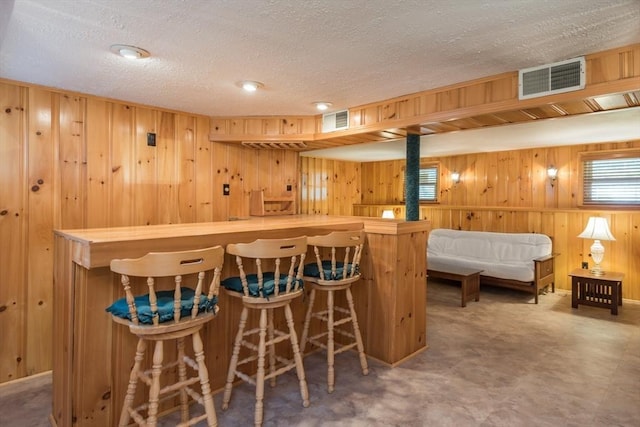 221 Andrew Ln, Hanson, MA 02341 - indoor dry bar with wood walls and a textured ceiling