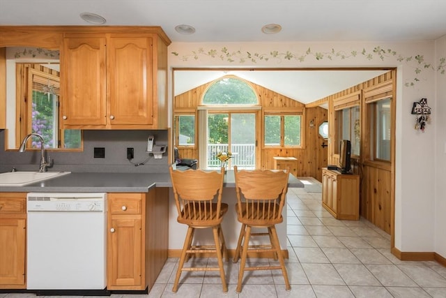 221 Andrew Ln, Hanson, MA 02341 - kitchen featuring white dishwasher, vaulted ceiling, light tile patterned flooring, and wooden walls