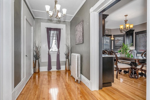 foyer featuring a chandelier, hardwood / wood-style floors, and radiator heating unit