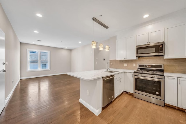 966 Hyde Park Ave Unit 301, Boston, MA 02136 - kitchen featuring stainless steel appliances, a sink, backsplash, white cabinets, and recessed lighting