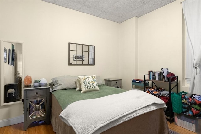 bedroom featuring wood finished floors and baseboards