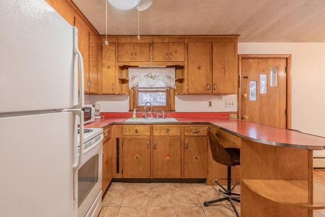 kitchen featuring sink, a kitchen breakfast bar, light tile patterned floors, kitchen peninsula, and white appliances