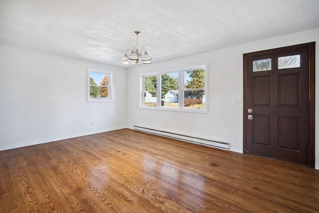 foyer entrance featuring a textured ceiling, an inviting chandelier, dark hardwood / wood-style flooring, and a baseboard radiator