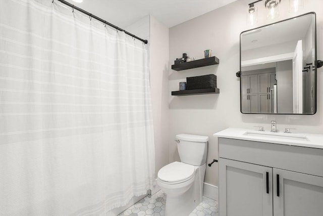 full bath with vanity, tile patterned floors, baseboards, and toilet