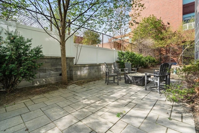 view of patio with a fenced backyard and an outdoor fire pit