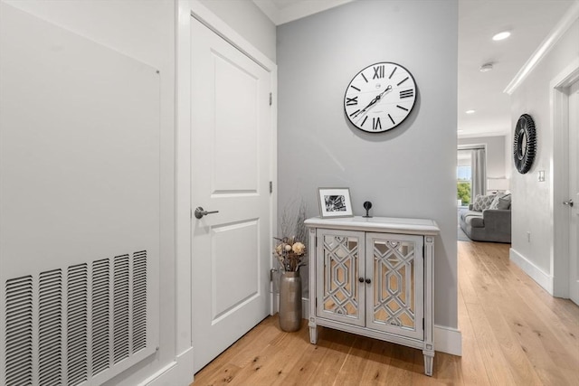corridor featuring recessed lighting, light wood-style flooring, and baseboards