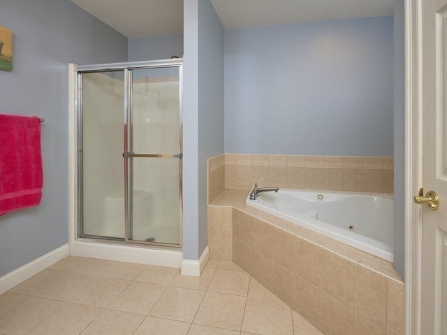 full bathroom with a stall shower, tile patterned flooring, a garden tub, and baseboards