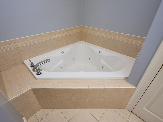 bathroom with tile patterned flooring and a whirlpool tub