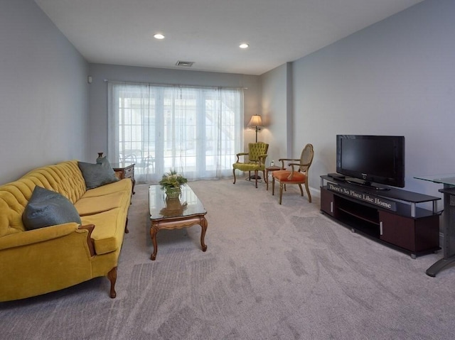 living room featuring recessed lighting, light colored carpet, and visible vents