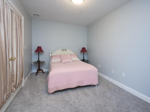 bedroom featuring light colored carpet, visible vents, and baseboards