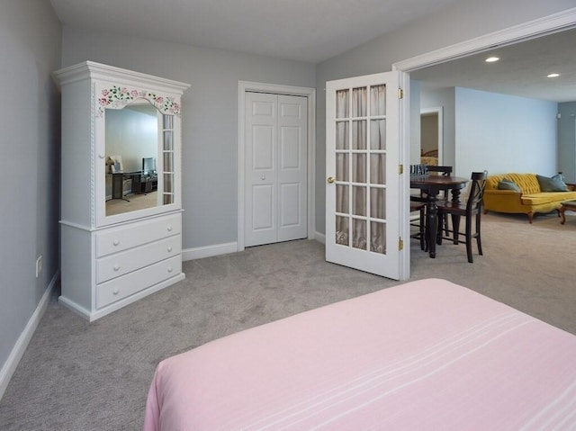 bedroom with baseboards, light colored carpet, french doors, a closet, and recessed lighting