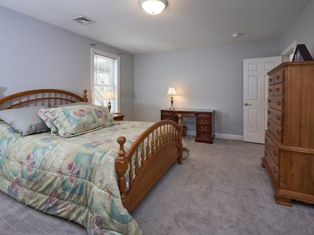 bedroom featuring light colored carpet, visible vents, and baseboards