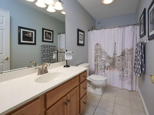 bathroom with toilet, vanity, and tile patterned floors