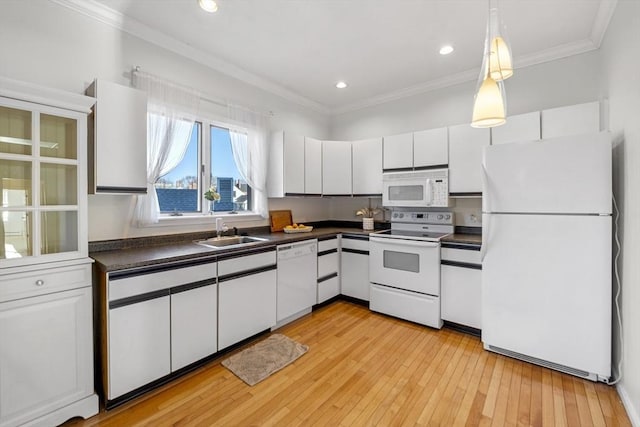 kitchen featuring white cabinets, white appliances, sink, and light hardwood / wood-style flooring