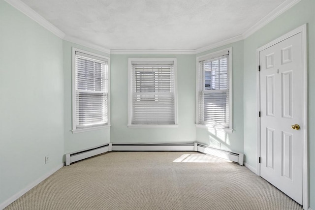 carpeted empty room featuring ornamental molding and a baseboard heating unit